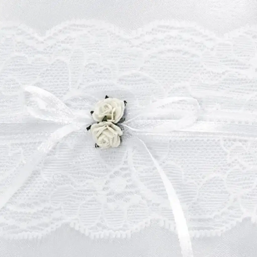 White wedding ring cushion with lace and white roses