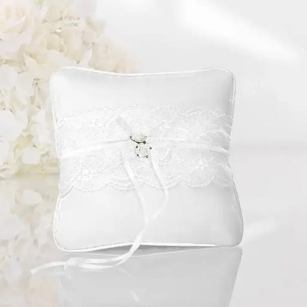 White wedding ring cushion with lace and white roses