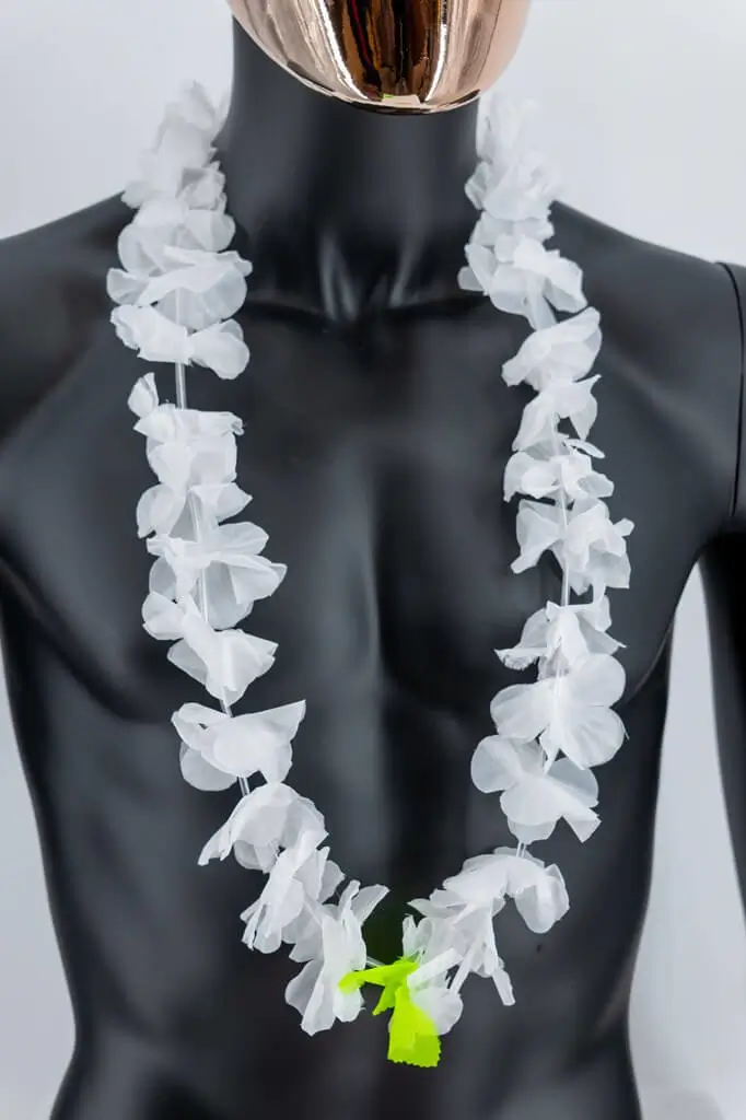 Hawaiian necklace with white flowers and green leaves